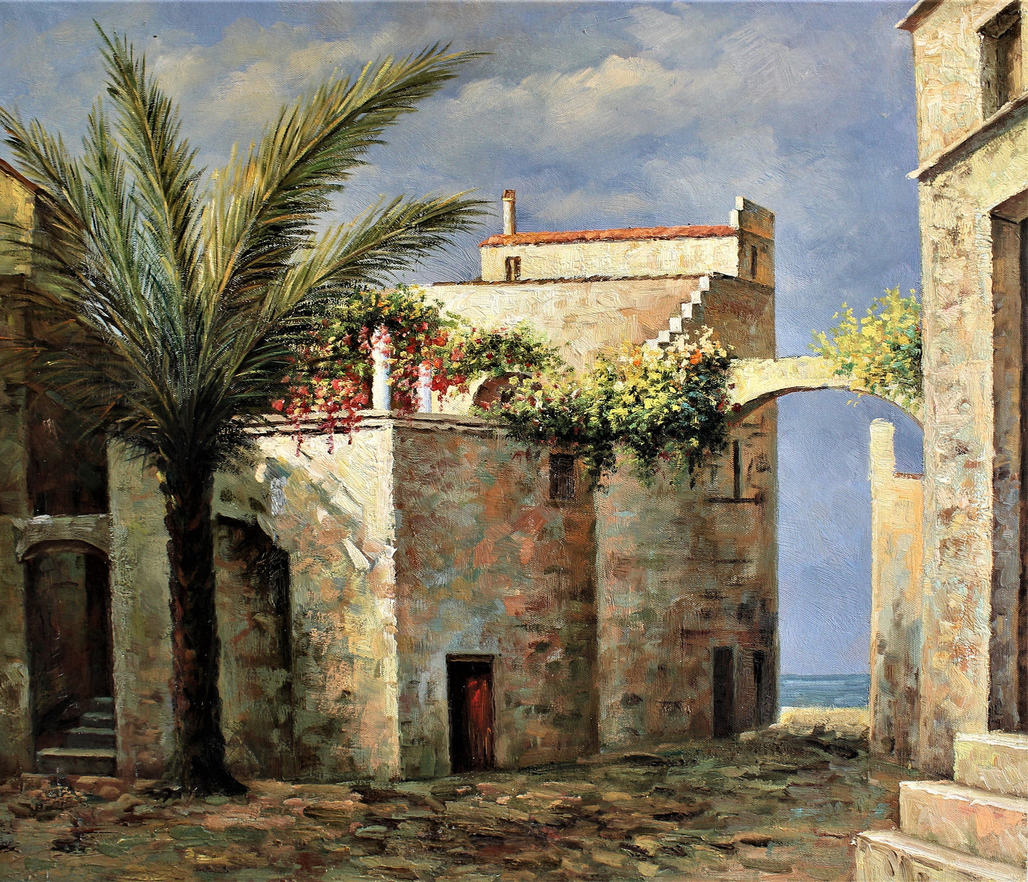 Stone buildings and a large palm tree