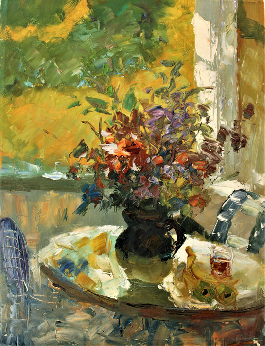 Sunny table with vase of flowers