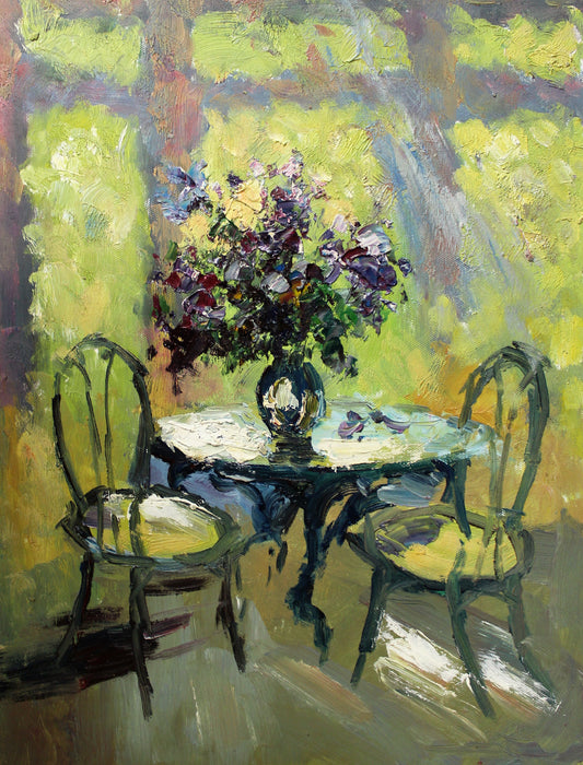 Floral arrangement on table with two chairs