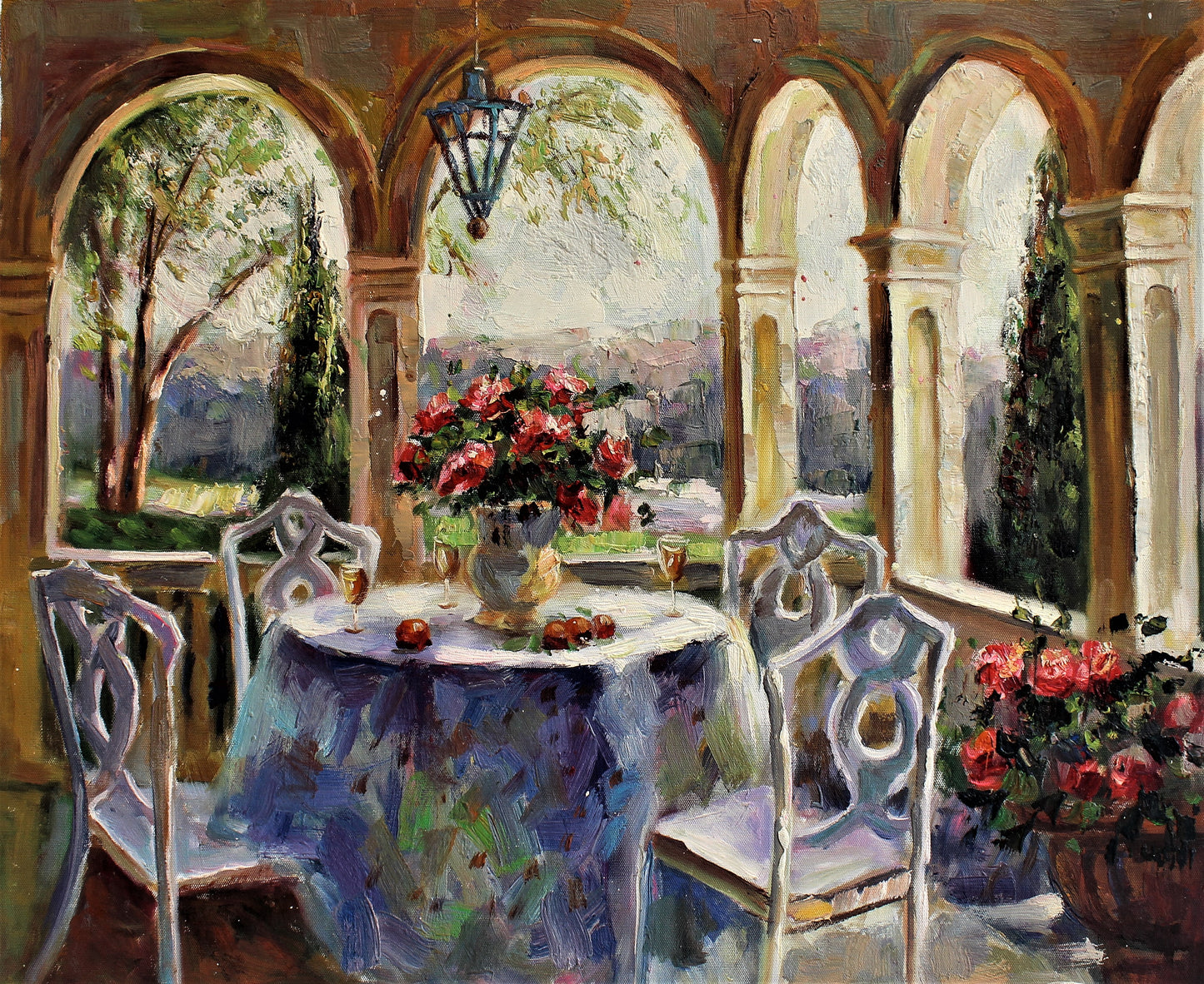 Table with floral arrangement on a porch with arches