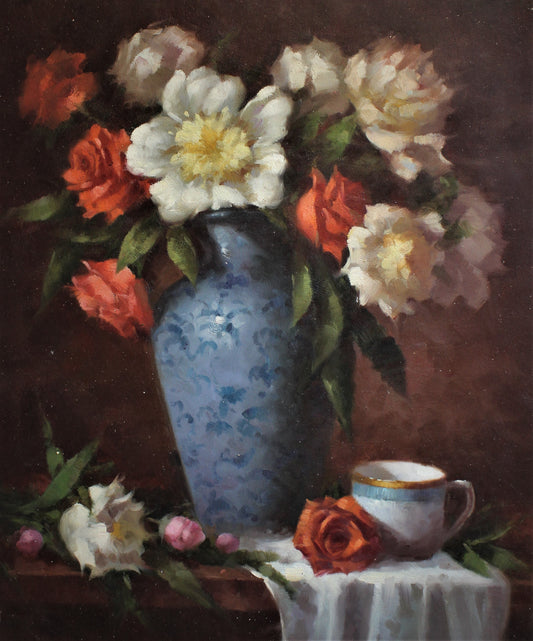 Nature morte d'une tasse de thé et de fleurs dans un vase bleu