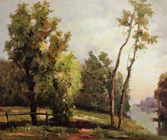 A fence and trees by the rivers edge