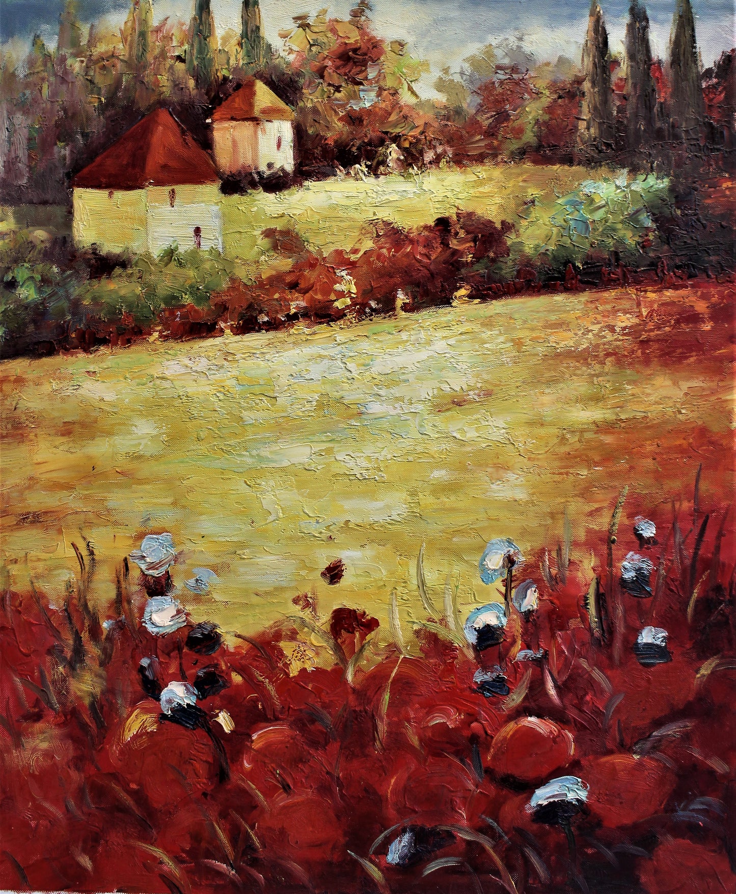 Yellow field with distant buildings
